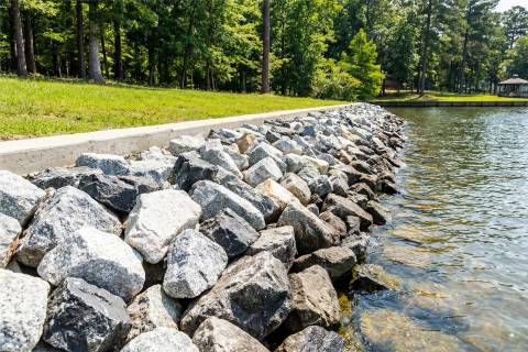 concrete curb with stone rip rap shoreline protection