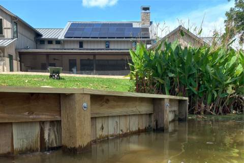 wooden bulkhead with decorative panels at residential canal