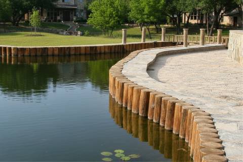 round piling bulkhead with stone coping and beach