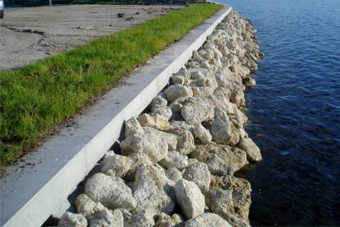 concrete seawall with stone rip rap protection