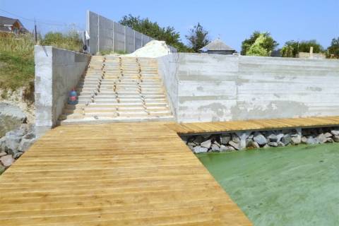 concrete seawall with stairs and dock