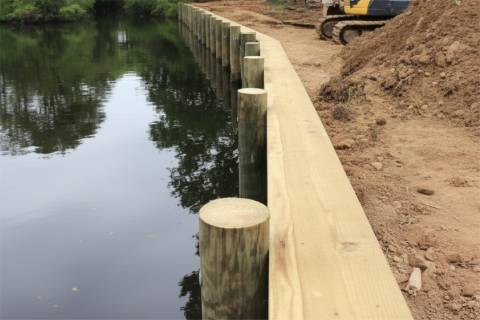 wooden retaining wall shoreline reinforcement piling construction