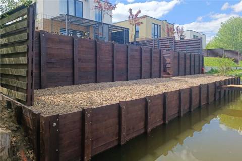 wooden retaining wall bulkhead shoreline gravel